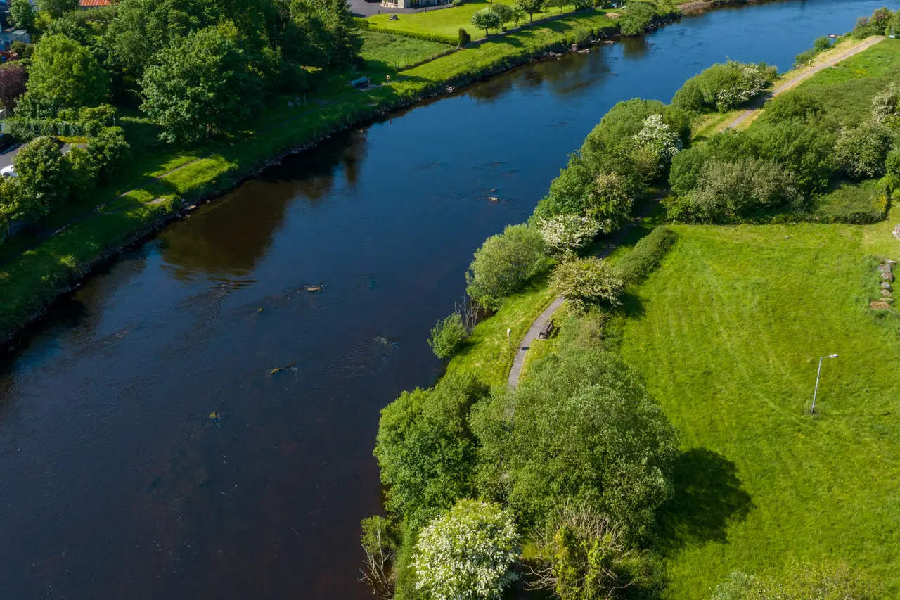 A river winding past open parkland